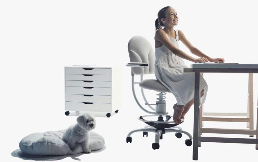 A girl in an office chair at her desk