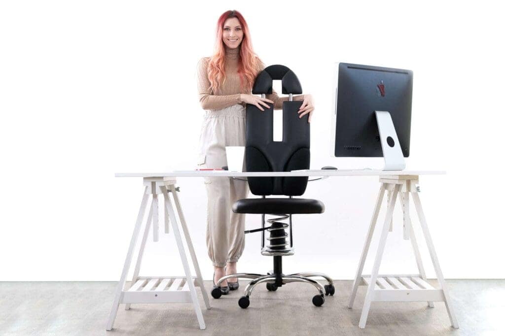 A girl standing next to the Pilot office chair in black